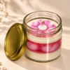 TabbyArt handmade floral jar candle with sculpted pink flower topper layered cream soy wax and translucent pink gel wax in clear glass jar with gold metallic lid